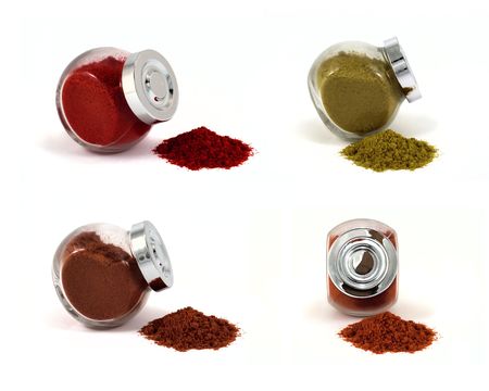 Four jars with spices on isolated white background, focus at jars capsの写真素材