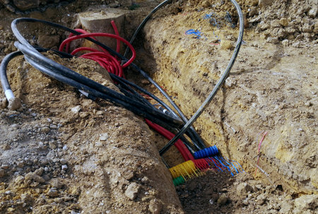 Electric cables on the ground in a construction site, closeup of photoの写真素材