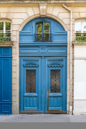 Paris, an old wooden door, typical building in the Maraisの写真素材
