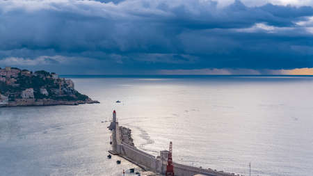 Nice, aerial view of the harbor and the lighthouse, stormy dayの写真素材