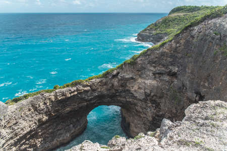 Guadeloupe, Marie-Galante island, the hole "Gueule Grand Gouffre", a beautiful seascape with a natural arch in the cliffsの写真素材