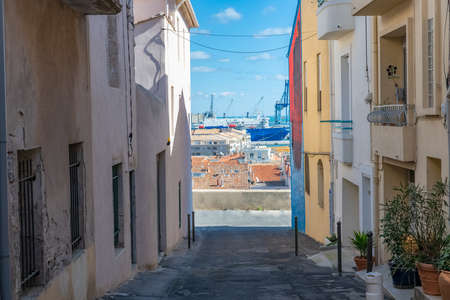 SÃ¨te in France, fisherboat at the quay, typical colorful facades in the harborの写真素材