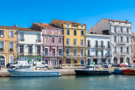 SÃ¨te in France, fisherboat at the quay, typical colorful facades in the harborのeditorial素材