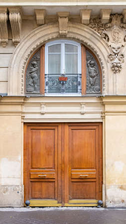 Paris, an ancient wooden door, typical building in the centerの写真素材