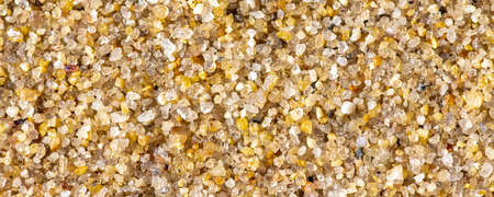 Large grains of sand on a beach, colorful backgroundの写真素材