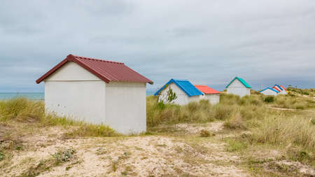 Gouville-sur-Mer, Normandy, colorful wooden beach cabins in the dunesの写真素材