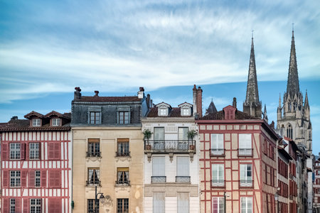Bayonne in the pays Basque, typical facades with colorful shutters in the historic center, with the cathedral Sainte-Marie in backgroundの写真素材