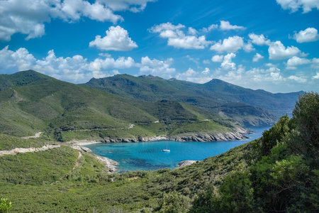 Corsica, seascape in the cap Corse, a beautiful creek with a boat, transparent water,  in summerの写真素材