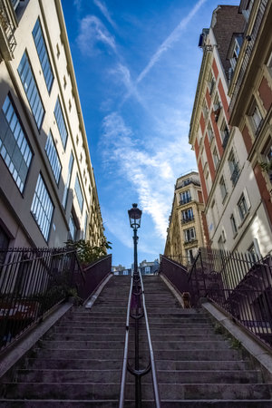 Paris, romantic staircase in Montmartre, typical buildings and floor lampの写真素材
