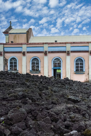 La Reunion, the Notre-Dame-des-Laves church in the village of Sainte-Rose, with the lava around, in the east coast of the islandの写真素材