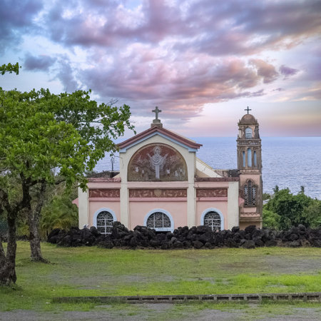La Reunion, the Notre-Dame-des-Laves church in the village of Sainte-Rose, with the lava around, in the east coast of the islandの写真素材