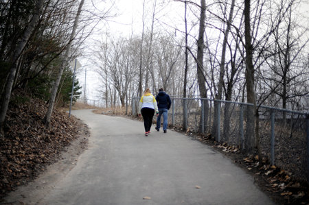 a couple is walking on a path in the forest