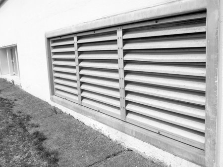 A closeup shot of a metal roller shutter in black and whiteの写真素材