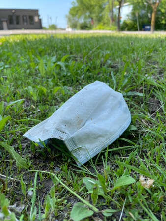 Surgical mask used on the floor during the Covid-19 pandemicの写真素材