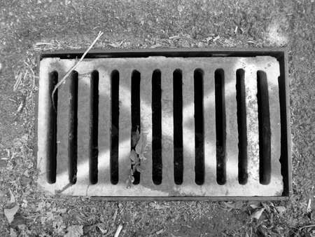 a sewer grate in the streetの写真素材