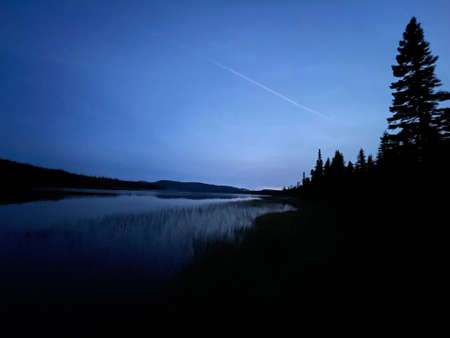 sunset over the lake in the forest in autumnの写真素材