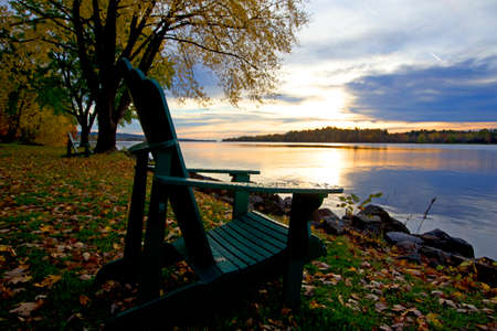 a park ferry on the edge of a river with a sunriseの写真素材