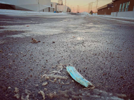 Surgical mask used on the floor during the Covid-19 pandemic in winterの写真素材