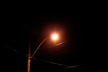 a lamppost in the nightの写真素材