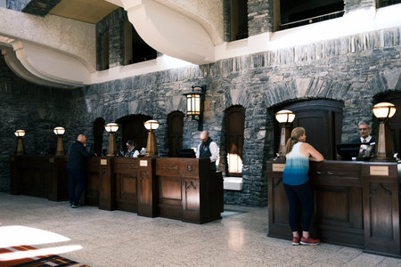 Receptionist at the entrance to the hotel in Fairmont Banff Springs Hotel, Alberta, Canadaのeditorial素材