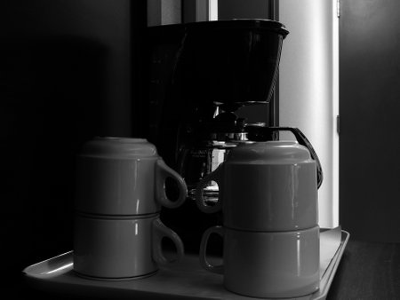 Coffee machine and two cups of coffee in black and whiteの写真素材