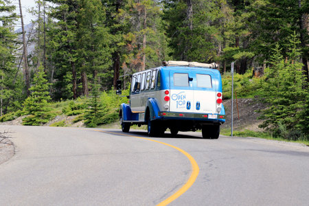 Tourist bus on the road in Banff, Alberta, Canadaのeditorial素材
