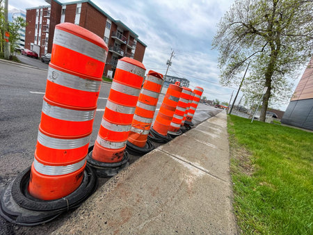 Traffic cones on the side of a road in a residential area