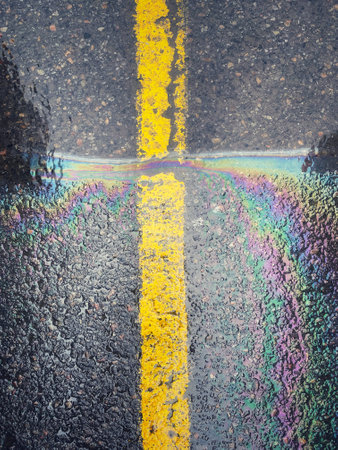 Rainbow painted on asphalt road with yellow line. Abstract background.の写真素材