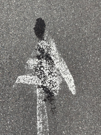 sign painted on the asphalt in the form of a manの写真素材