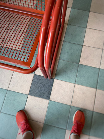 A red metal bench in a shopping centerの写真素材