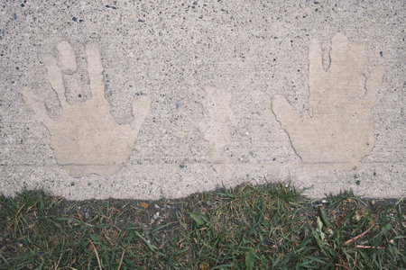 Handprint on the cement floor with green grass in the background.の写真素材