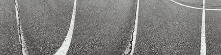 Black and white lines on the asphalt road. Abstract background for design.