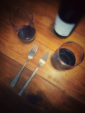 Wine and glasses on a wooden table with copy space. Toned.の写真素材