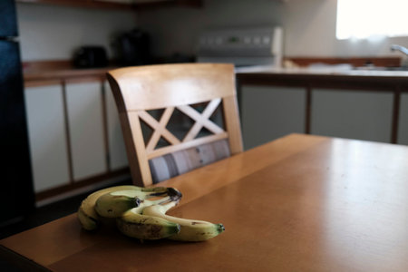 Bananas on a wooden table in the kitchen. Selective focus.の写真素材
