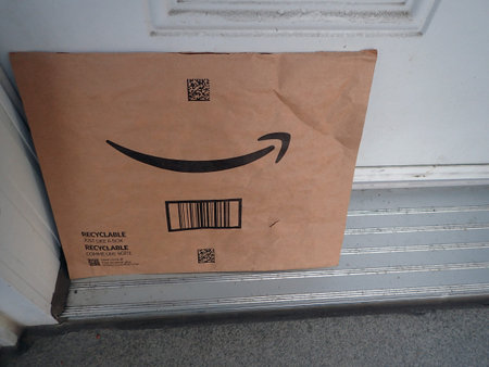 Close-up of an Amazon box being delivered outside