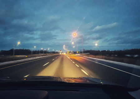 Driving on the highway in the early morning at sunset. Motion blur.の写真素材