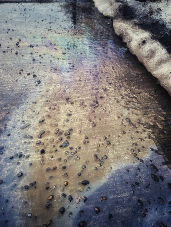 Gasoline on the sidewalk. Rainbow on wet asphalt when thawingの写真素材