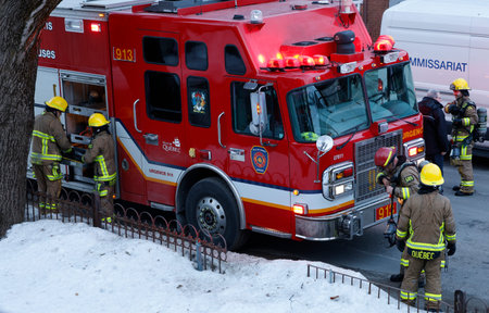 Firefighters extinguish a fire in the city on a winter day.のeditorial素材