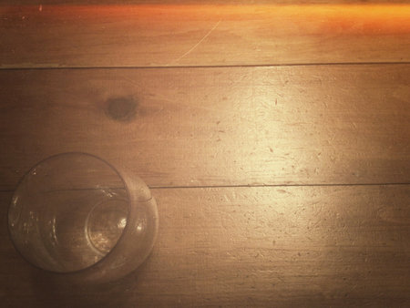Empty glass on wooden table. Top view. Copy space for text.の写真素材