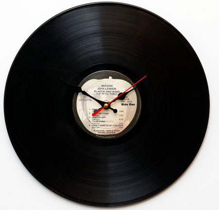 Vinyl record with a clock on a white background, top view. Clock with John Lennon vinyl, Imagineのeditorial素材