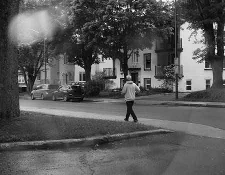 A person walks in the city in the rain