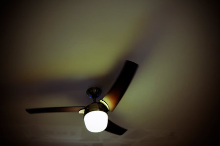 Ceiling fan on the wall in the dark. Selective focus.の写真素材