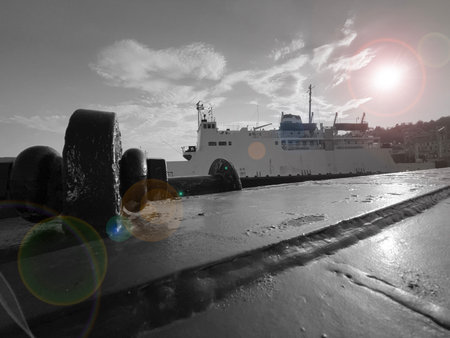 A ferry docked at the quay. Halo of the sun.