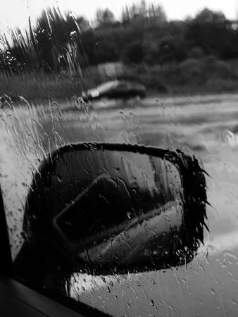 Raindrops on the windshield of a car. Black and white photos.