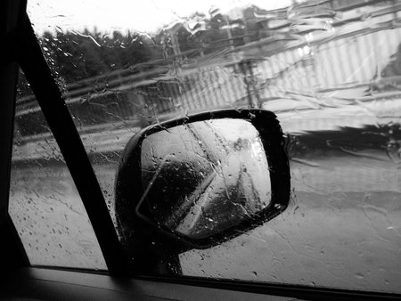 View from inside the car on a rainy day. Black and white.