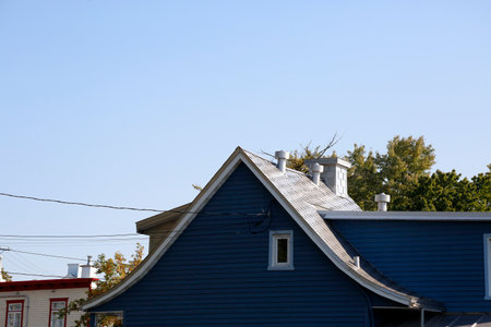 roofs of houses in the village against the blue sky.の写真素材