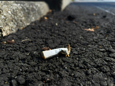 Broken cigarette on the asphalt road. Close-up. Selective focus.の写真素材