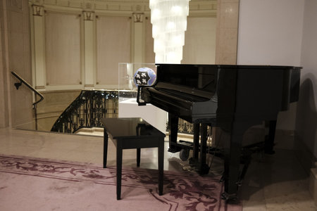 Black grand piano in a hotel lobby. Musical instrument for playing music.のeditorial素材