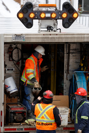 Workers unload a truck from a warehouse to a truck. Telecommunications workers unload cargo from truck to carry out work.のeditorial素材