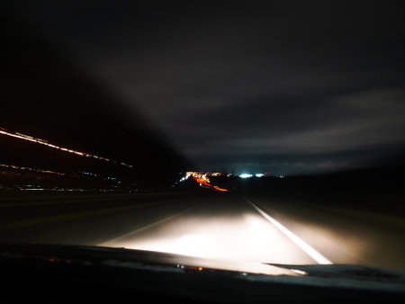 Driving on a highway at night. Blurred motion of car headlights.の写真素材
